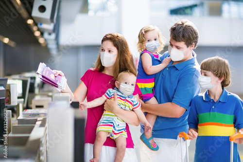 Family in airport in face mask. Virus outbreak.