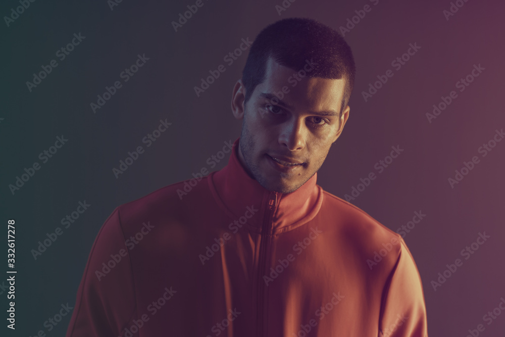 Studio close-up portrait of attractive male model. Color flash studio light