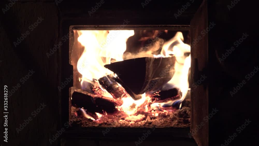 Man hand open and close metall door furnace bake oven with fire burns firewoods Man hand open and close metall door furnace bake oven with fire burns firewoods
