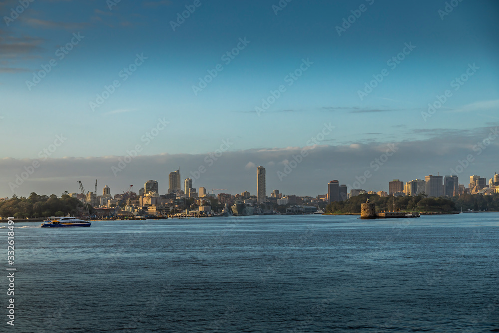 Fototapeta premium The skyline of Sydney, New South Wales in Australia during a cloudy but warm day in summer.