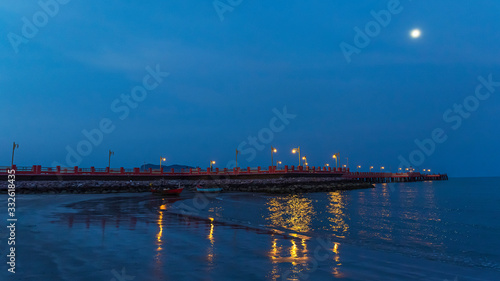 The red bridge and the people who exercise Walk to see the view at Prachuap Bay in the evening time in Thailand.