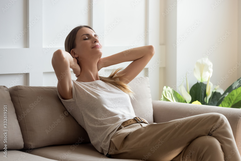 Serene beautiful woman with closed eyes napping resting on cozy sofa, tranquil young female with hands behind head relaxing on comfortable couch at home, daydreaming and meditating, lazy weekend Serene beautiful woman with closed eyes napping resting on cozy sofa, tranquil young female with hands behind head relaxing on comfortable couch at home, daydreaming and meditating, lazy weekend