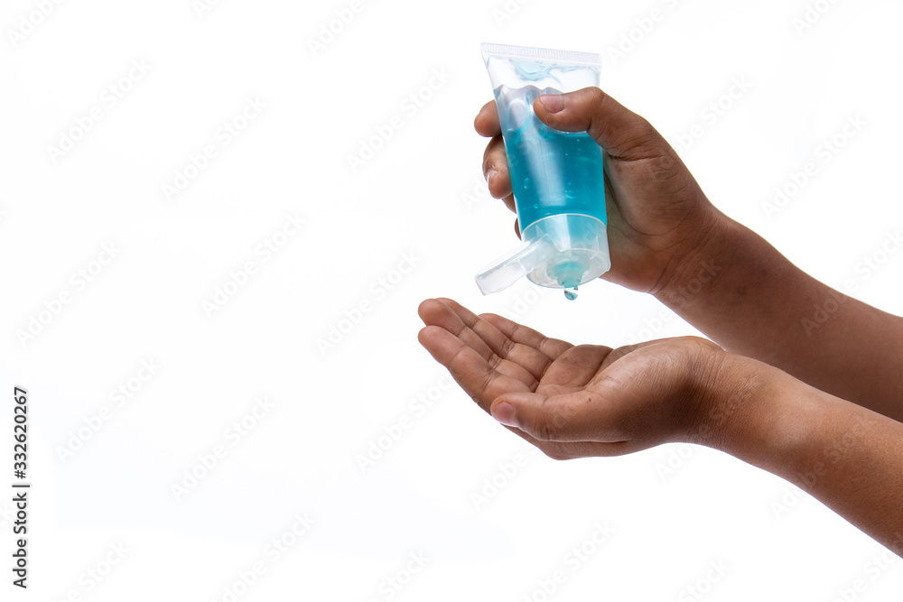 Child hand using hand skin sanitizer gel tube for washing hand isolated on white background. Health awareness for pandemic protection. - anti germ and preventative concept. Child hand using hand skin sanitizer gel tube for washing hand isolated on white background. Health awareness for pandemic protection. - anti germ and preventative concept.