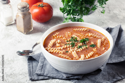 Obraz na plátně Tomato soup with fusilli pasta in the bowl