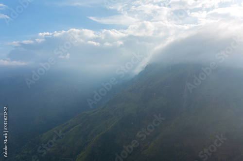 Mountain landscape  green slopes. Beauty of mountains. Little Adam peak  mountain in the fog view from the jungle