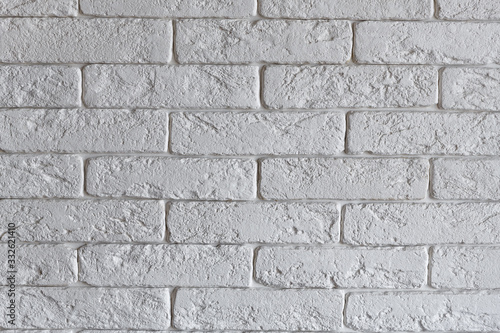 Interior brickwork of white decorative plaster brick on the wall. Loft style interior design.