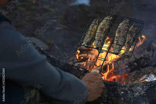 Photography trout grill on charcoal / fried fish trout on coals, trek food