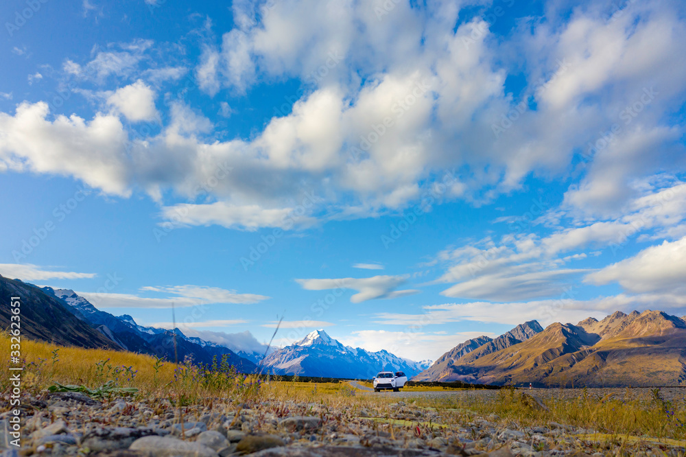 Fototapeta premium Offroad car with snow mountains in the back