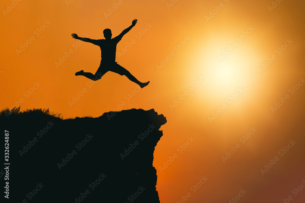 man is jumping happy with success on mountain cliff . Business Leadership concept .for your work.