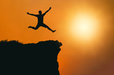 man is jumping happy with success on mountain cliff . Business Leadership concept .for your work.