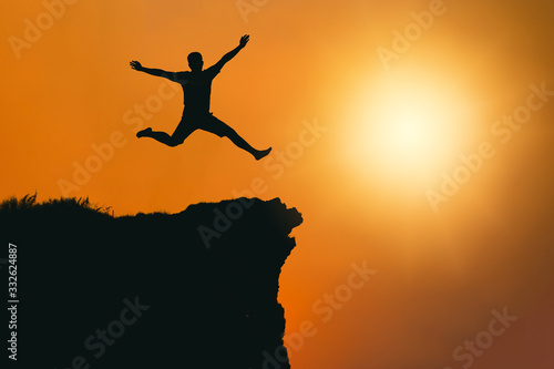 man is jumping happy with success on mountain cliff . Business Leadership concept .for your work.