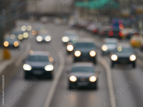Defocused photography of the big traffic on the city street. Road is filled our by cars. Rush hours. Lifestyles of big city concepts. Frontal and back  view