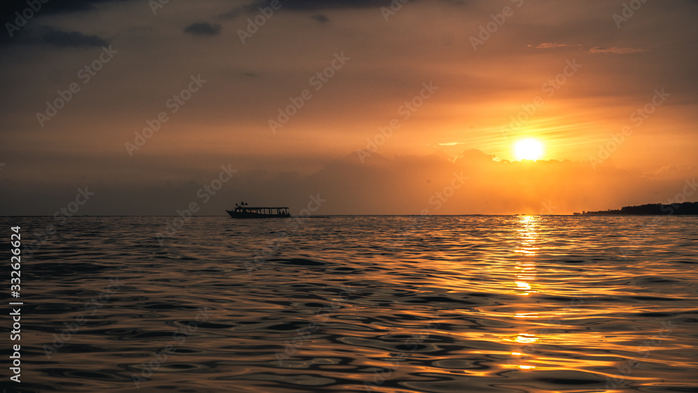 Boat on the sea horizon during sunset