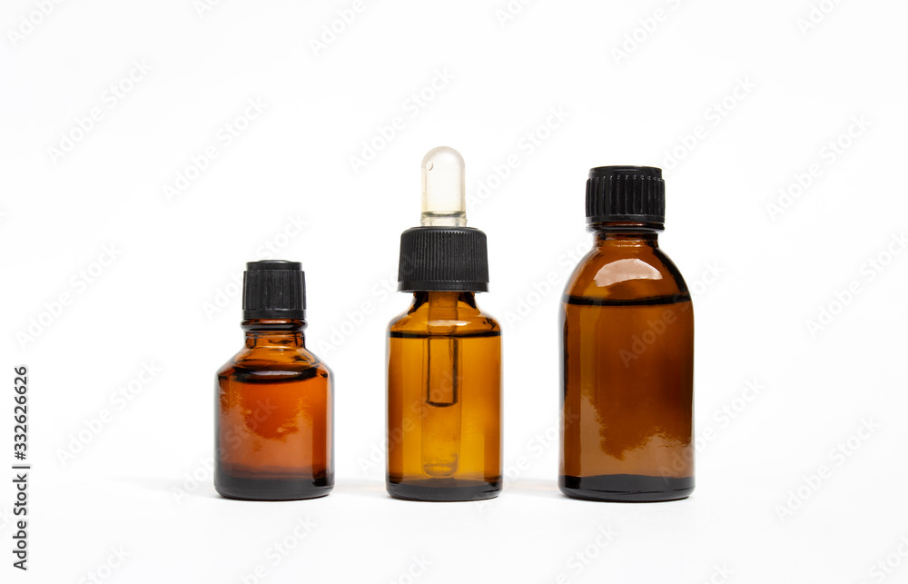 Various amber glass bottles for cosmetics, natural medicine , essential oils or other liquids isolated on a white background.High resolution photo.