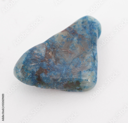 A blue gemstone photographed against a white background