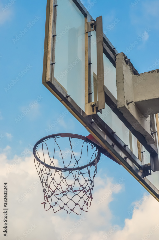 Basketball hoop with blue sky background
