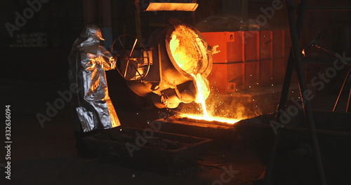 Fototapeta The molten metal is poured into the mold