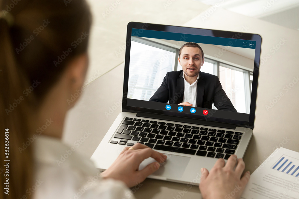 Back view of female employee talk with male businessman on webcam laptop conference, woman worker negotiate with man employer brainstorm on video call from home, online consultation concept Back view of female employee talk with male businessman on webcam laptop conference, woman worker negotiate with man employer brainstorm on video call from home, online consultation concept