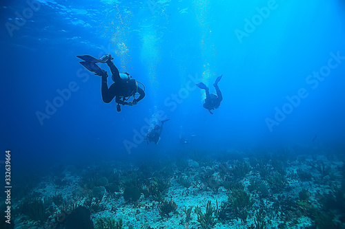 diver flippers view from the back underwater, underwater view of the back of a person swimming with scuba diving