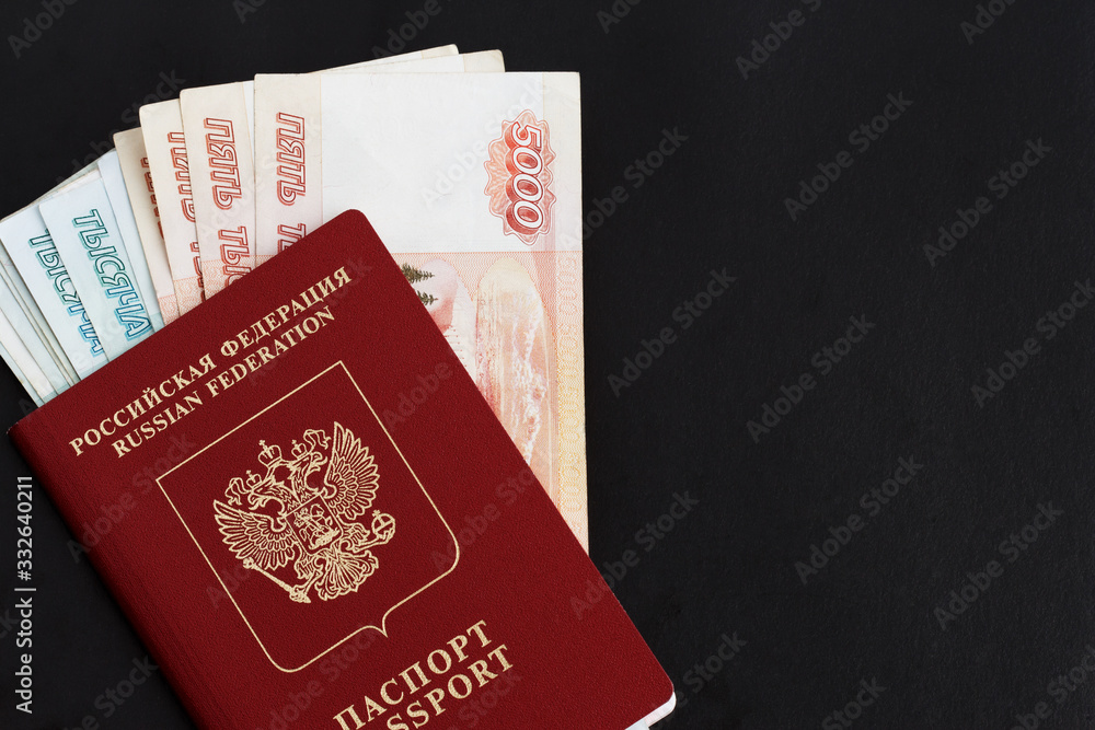 Russian foreign passport on a black background. Copy space. Passport with money for travel. Russian foreign passport on a black background. Copy space. Passport with money for travel.