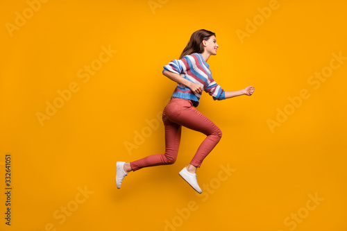 Full size profile side photo of content lovely youth girl jump run after fall bargain novelties wear good look clothes pullover shoes isolated over bright color background
