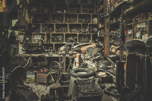 old abandoned mechanical workshop with many messy things photo