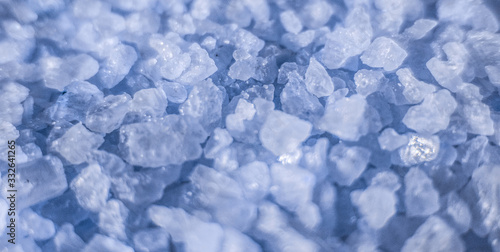 Sea salt close up as illustration of relaxing aromatherapy spa and grainy blue texture background backdrop