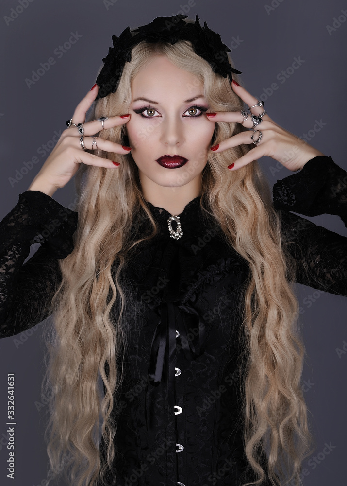 Beautiful gothic woman with crown posing on dark background. Beautiful gothic woman with crown posing on dark background.