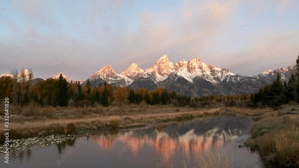 autumn sunrise view of grand teton and its reflection at schwabacher landing in grand teton national park at jackson hole, wyoming autumn sunrise view of grand teton and its reflection at schwabacher landing in grand teton national park at jackson hole, wyoming