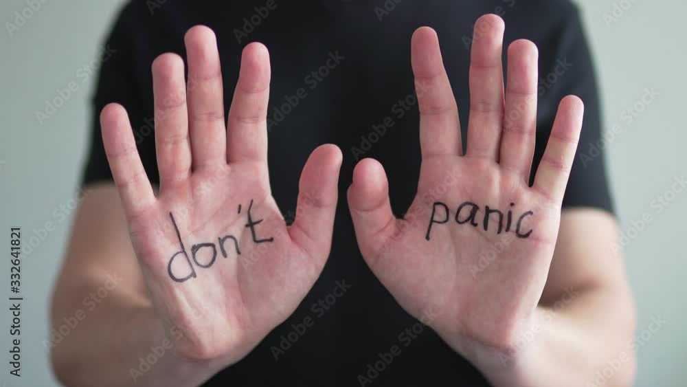Don't panic. Text on men's hands, close-up. The concept of the coronavirus epidemic and the crisis Don't panic. Text on men's hands, close-up. The concept of the coronavirus epidemic and the crisis