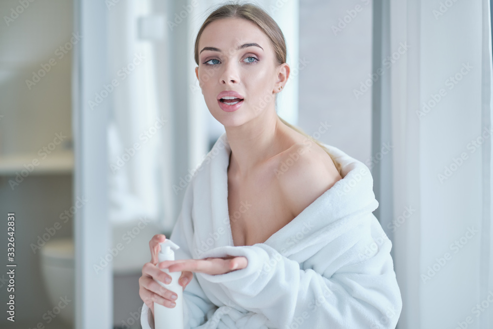 Hand sanitizing. woman in a bathrobe disinfects hands. virus protection Hand sanitizing. woman in a bathrobe disinfects hands. virus protection