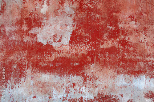 background texture of an old wall with peeling red paint