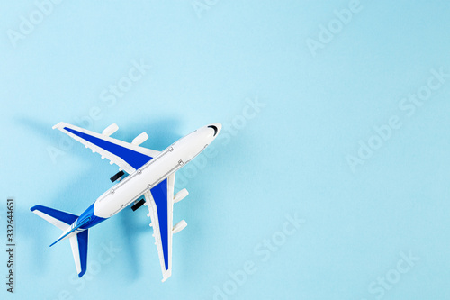 Model plane, airplane on blue pastel color background. Summer travel or vacation concept