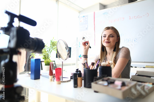 Female Blogger Filming Makeup Beauty Tutorial. Cosmetic Product Review Concept. Young Caucasian Woman Recording Video Blog on Camera. Trendy Fashion Vlogger Girl Online Translation at Home