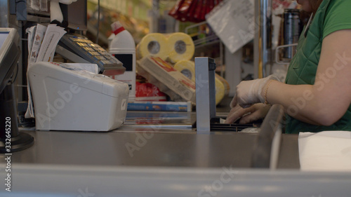 Hands of cashier putting cash in cash box