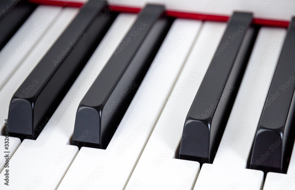 close-up of piano keys. close frontal view, black and white piano keys, viewed from side above close-up of piano keys. close frontal view, black and white piano keys, viewed from side above