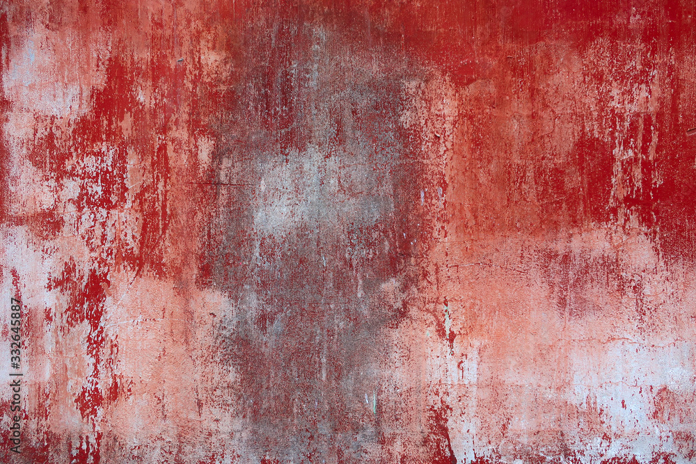 Background texture of an old concrete wall with peeling red paint