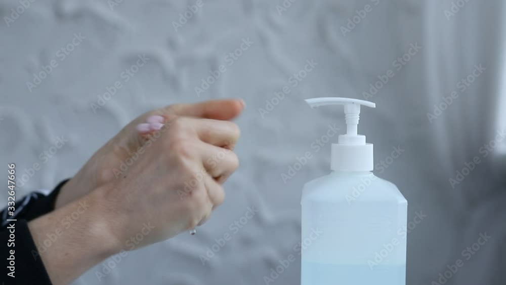 Close-up of woman hands using hand sanitizer gel to prevent spreading virus (such as corona virus / covid-19 / sars-cov-2) or bacteria. real time footage. Close-up of woman hands using hand sanitizer gel to prevent spreading virus (such as corona virus / covid-19 / sars-cov-2) or bacteria. real time footage.