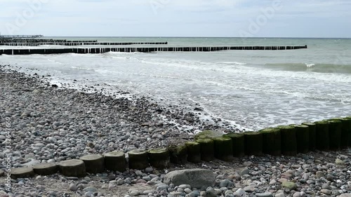 Baltic sea coast with traditional wooden groynes along. stormy weather. photo