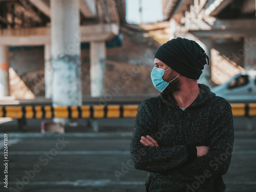 Hipster Man In A Medical Mask For Protection Against Virus Flu Or Coronavirus Outdoor. Corona Virus Pandemic. Epidemic Viral Respiratory Syndrome. 2019-nCoV. High Quality Photo © yavorovich