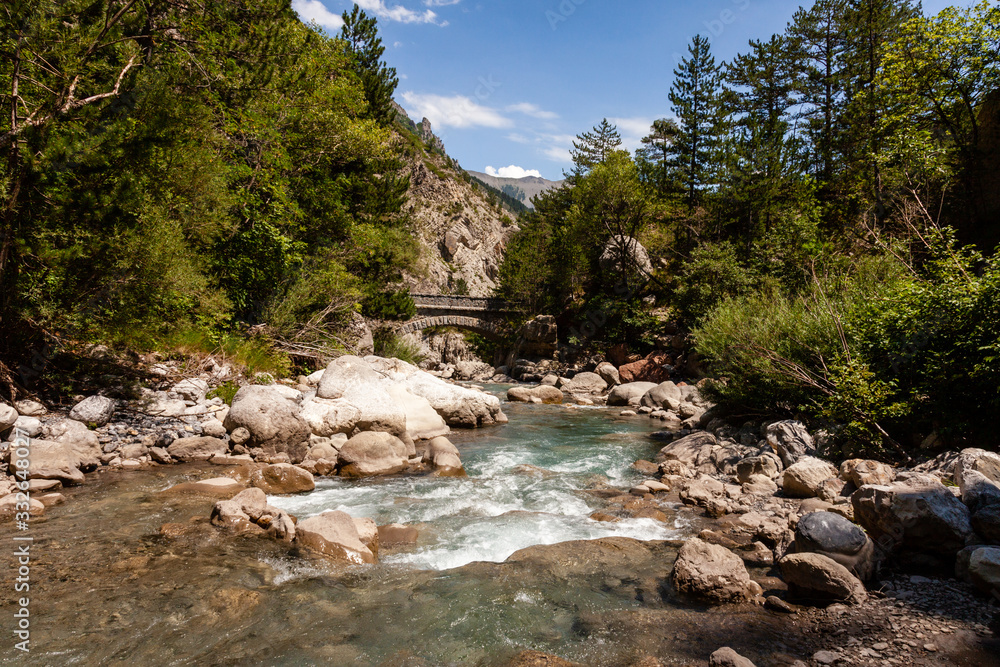 River in mountain forest area. Bridge Point sur le Bes river in back. Provence, France, Europe. River in mountain forest area. Bridge Point sur le Bes river in back. Provence, France, Europe.