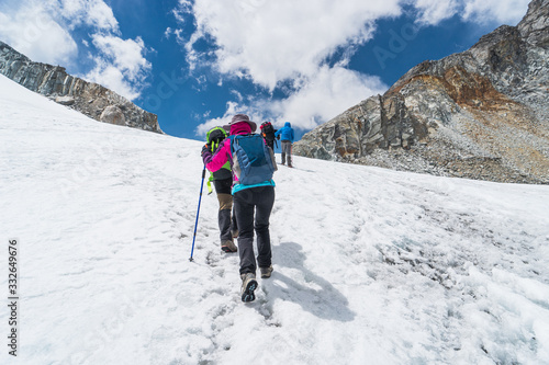Trekkers walking on glacier at Chola pass to Gokyo village, Everest region in Himalaya mountain range, Nepal