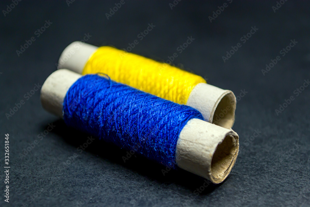 Sewing multi-colored threads on a black background Sewing multi-colored threads on a black background