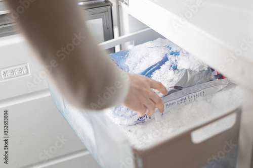 take ice cubes out of the freezer photo