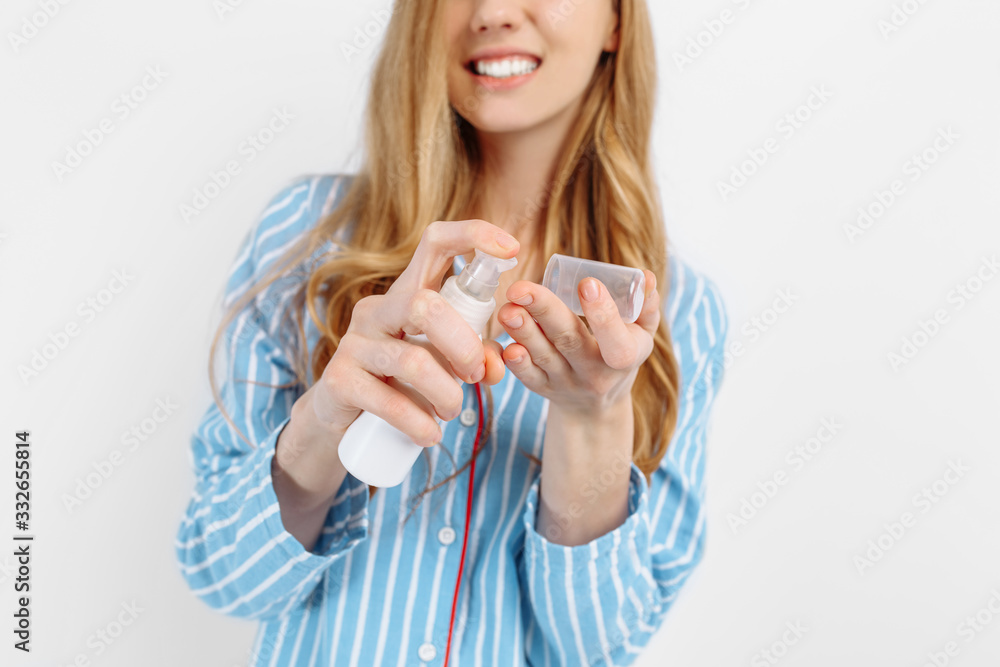 girl in pajamas holding hand cream, close -up girl in pajamas holding hand cream, close -up