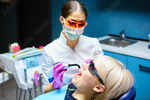 Young dentist at work in the office.