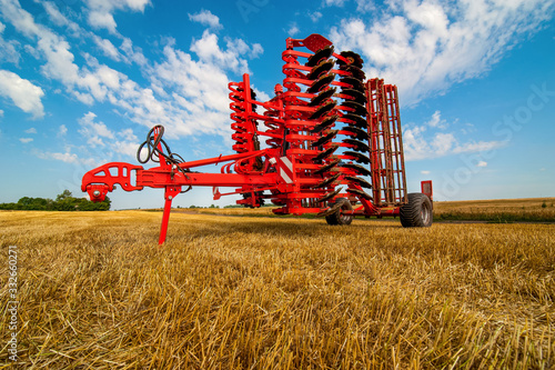 Tablou pe pânză Red harrow folded for transportation for cultivating the land
