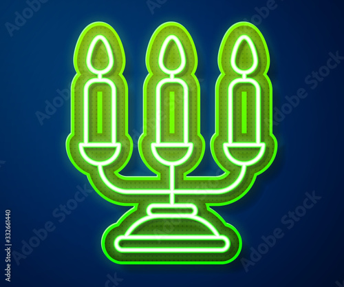 Glowing neon line Candelabrum with three candlesticks icon isolated on blue background. Vector Illustration
