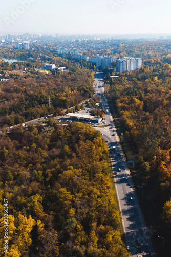 Fototapeta Naklejka Na Ścianę i Meble -  road with cars to city from forest