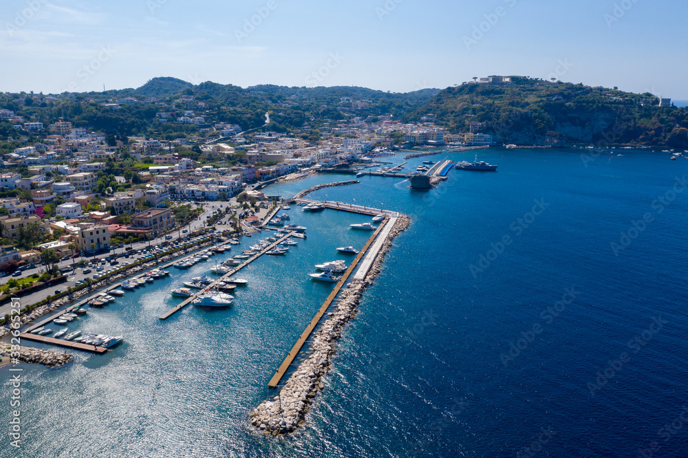 Aerial drone photo of boat docked in harbour in the island of Ischia, Italy